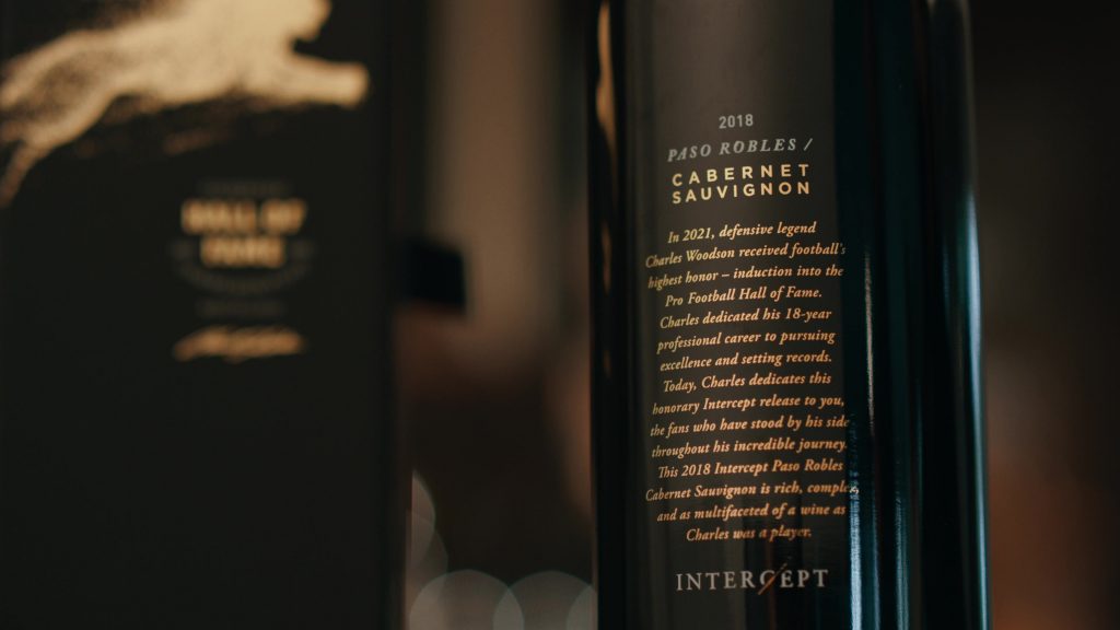 Close-up view of a 2018 Paso Robles Cabernet Sauvignon wine bottle with an honorary label dedicated to Charles Woodson's induction into the Pro Football Hall of Fame.